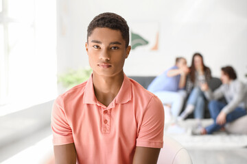 Lonely African-American teenage boy in room. Stop racism