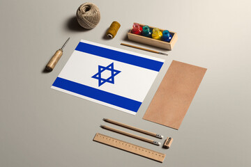Israel calligraphy concept, accessories and tools for beautiful handwriting, pencils, pens, ink, brush, craft paper and cardboard crafting on wooden table.