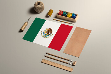 Mexico calligraphy concept, accessories and tools for beautiful handwriting, pencils, pens, ink, brush, craft paper and cardboard crafting on wooden table.
