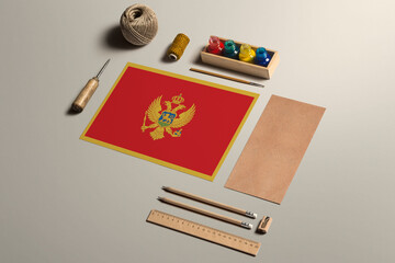 Montenegro calligraphy concept, accessories and tools for beautiful handwriting, pencils, pens, ink, brush, craft paper and cardboard crafting on wooden table.