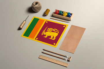Sri Lanka calligraphy concept, accessories and tools for beautiful handwriting, pencils, pens, ink, brush, craft paper and cardboard crafting on wooden table.