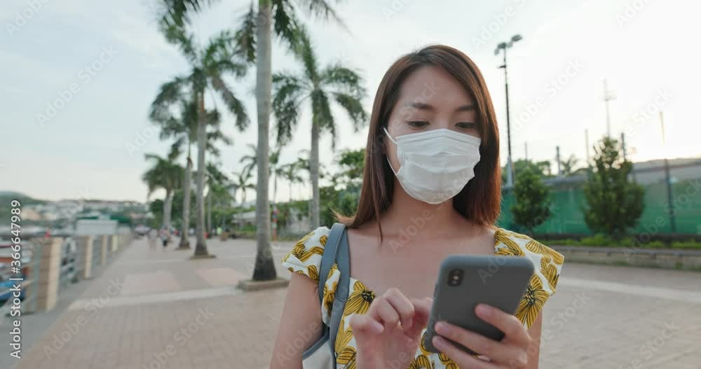 Poster Woman wear face mask and use of mobile phone in city