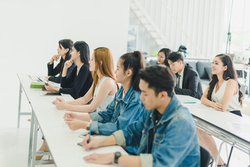 Asians attend seminars and listen to lectures from speakers in the training room. 