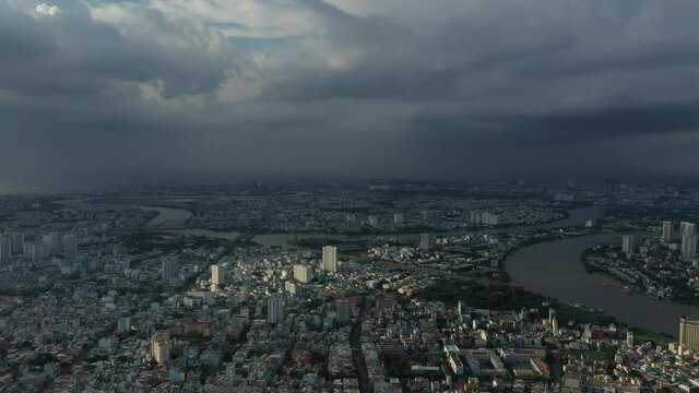 drone shot a storm approaches a densely populated area of a city. camera moves in slowly