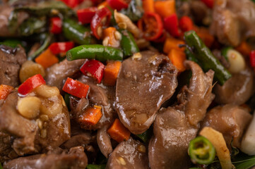 Stir-fried chicken liver basil on banana leaves in a black dish