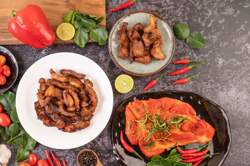 Pork cutlet in a white plate on black cement.