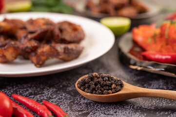 Pepper seeds in a wooden spoon.