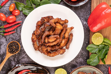 Pork cutlet in a white plate on black cement.