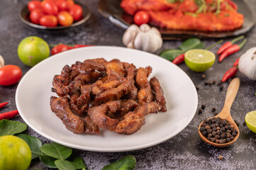 Pork cutlet in a white plate on black cement.