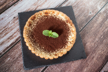 A top view of a delicious chocolate tart with mint on top