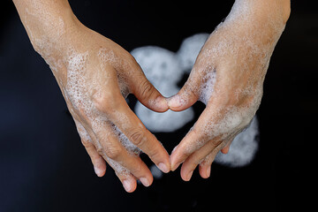 Closeup of people who wash their hands, hand and hand in separate heart shape The concept of cleanliness and body care