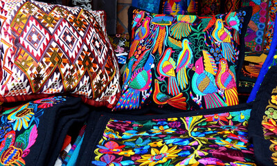 Close up of сolorful embroidered decorative pillows and textiles at the artisan's market in Otavalo, Ecuador