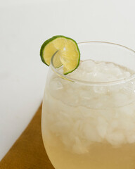 Limeade in curved-bottom glass with crushed ice and twist of lime. 
