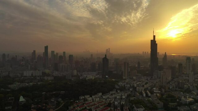 sunset time golden hour flight over nanjing downtown cityscape aerial panorama 4k china