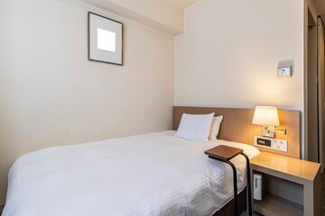 Fototapeta na wymiar Single bed in modern small bedroom at apartment