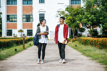 Male and female students wear a face Chill and stand in front of the university.