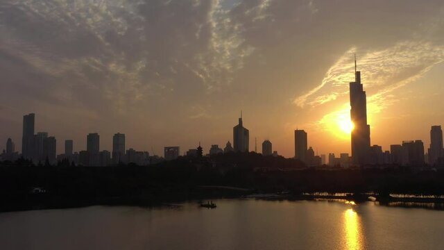 sunset time flight over nanjing city famous downtown tower lakeside bay aerial panorama 4k china