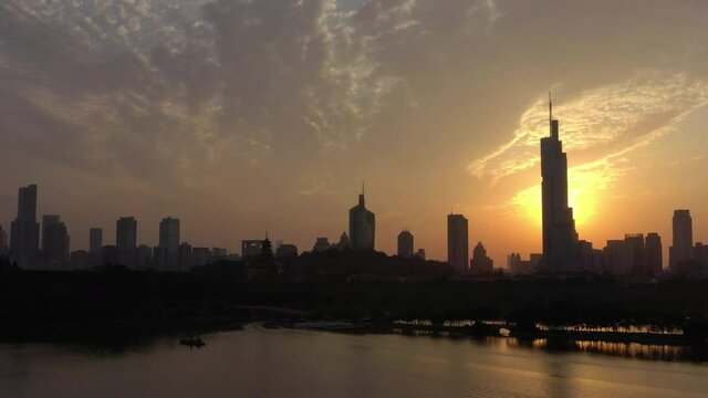 sunset time flight over nanjing city famous downtown tower lakeside bay aerial panorama 4k china