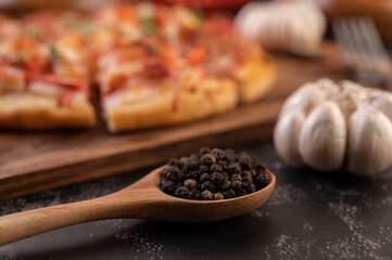 pizza placed on a wooden plate.