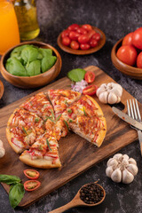 pizza placed on a wooden plate.