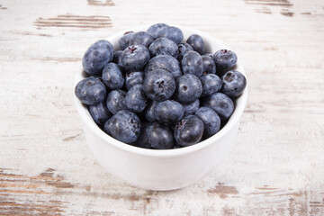 Fresh blueberries in glass bowl, natural source of minerals, healthy dessert concept
