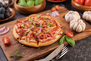 pizza placed on a wooden plate.