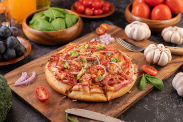 pizza placed on a wooden plate.