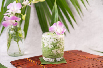 Dessert in a glass placed on a banana leaf.