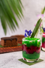Dessert in a glass placed on a banana leaf.
