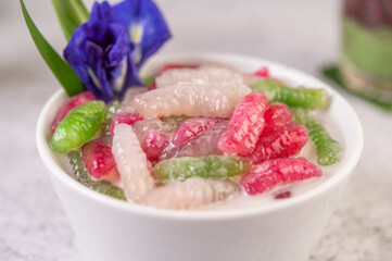 Desserts in cups placed on cement floor.