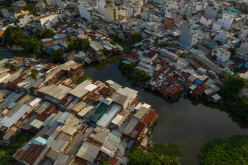 colorful old residential and business area resembling a crowded shanty town built along a canal from aerial top down view