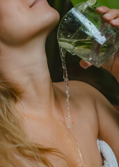 A stream of clear water pours down the girl's neck.