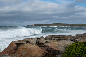 Fototapeta premium Beautiful big splashing blue wave, after a big storm