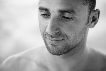 Black and white portrait of handsome happy, sexy man with body, surfer .