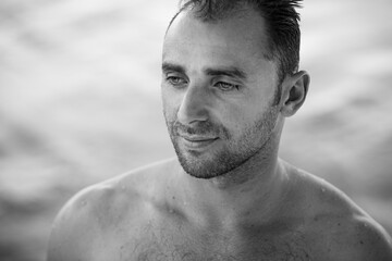 Black and white portrait of handsome happy, sexy man with body, surfer .
