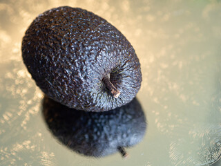 Closeup of avocado on silver plate from left view
