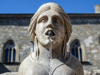 Bergamo, Italy. Close-up of the sphinx from whose mouth the water of the fountain flows. The Contarini fountain located at the main square at the old town. Best monument of the city