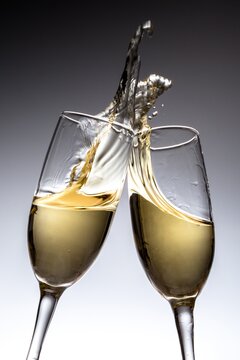Toasting Champagne Flutes on Grey Background