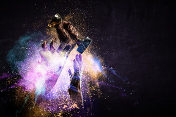 Hand holding up a gold trophy cup against dark background