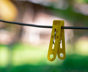 The yellow cloth clip is on the clothesline.