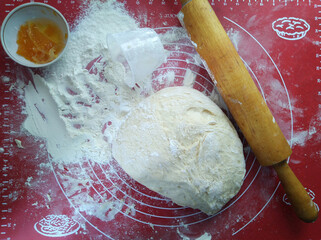 Flour, filling, rolling pin and dough on the table.