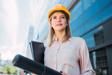 Professional architect woman standing outdoors.