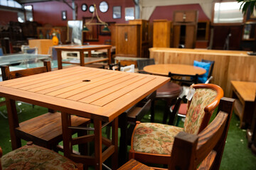 Wooden tables, chairs and other furniture offered for sale in store