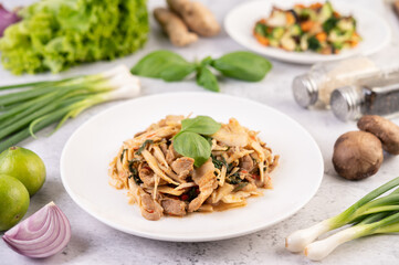Bamboo shoot curry, add pork into a white dish.