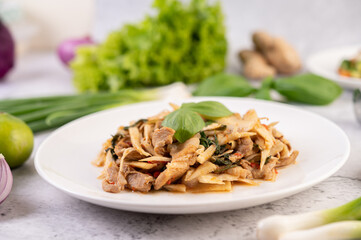 Bamboo shoot curry, add pork into a white dish.