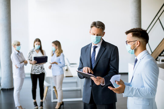 Office workers have a meeting with face masks as a protection from coronavirus