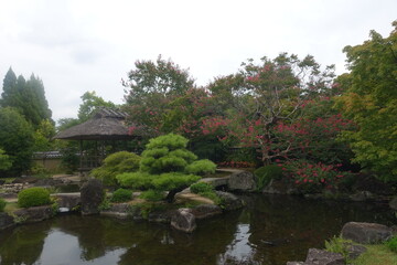 Fototapeta na wymiar Kokoen (好古園, Koko-en) garden view with pond and reflection, a Japanese garden located next to Himeji Castle in Hyogo Prefecture, Japan
