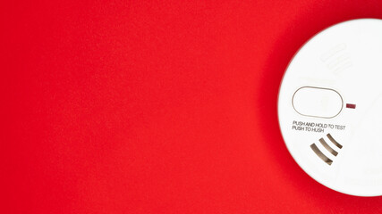 Smoke Alarm flat lay isolated on a red background with copy space