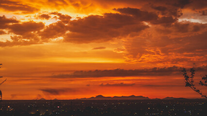 beautiful sunset with cloudy skies over the city and mountains 