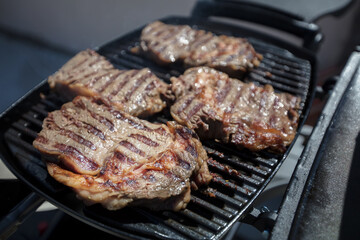 Grilled meat. Roasted piece of beef during cooking.